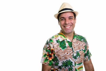 Studio shot of young happy Persian tourist man smiling isolated 
