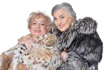 Portrait of beautiful senior women in fur coats