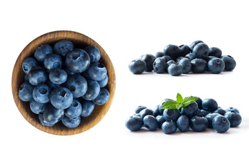 Blueberries in a wooden bowl. Ripe blueberries with copy space for text. Blueberry isolated on white. Bilberries  on a white background. Top view. Blueberries on a white background. 