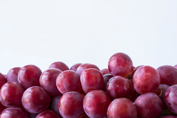 Red grapes on white background. Top view.  Bunch of grape on white background.  Pink bunch grape on white.