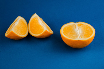 juicy orange sliced on a blue background, Popular healthy fruit.