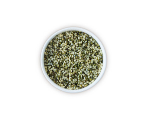 Hemp seeds isolated on white. Bowl with hemp seeds isolated on white background. Peeled raw hemp seeds in bowl. Top view.