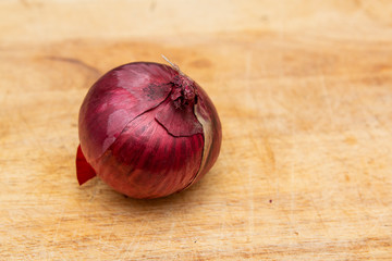 red onion on a wooden chopping board