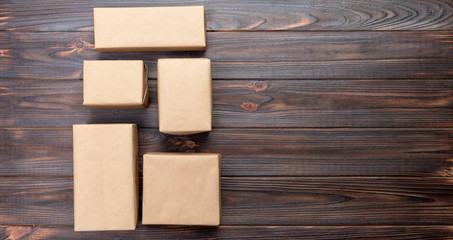 cardboard box on white wooden background, Brown mail package top view