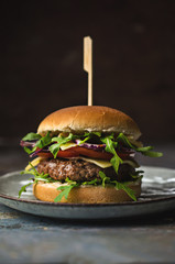Tasty hamburger with vegetables and rucola