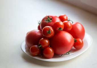 red tomatoes on white plate