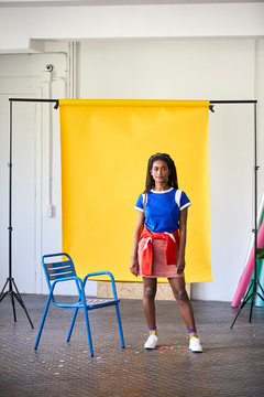 Professional Standing Against Yellow Backdrop