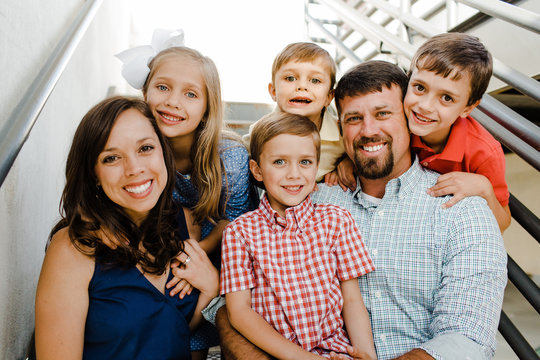 Happy Family of 6 Sitting Together