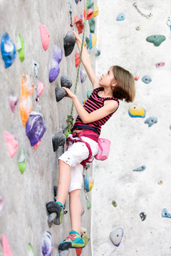 Beautiful girl rock climbing