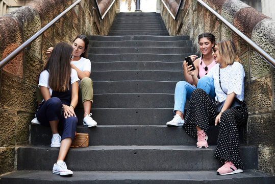 Girl friends hanging out in the street in summer. Friendship.