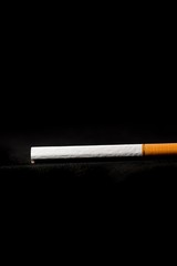 stop smoking concept, a broken cigarette isolated against black, World Tobacco Day