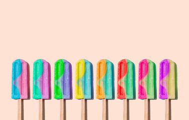 Row of rainbow-colored icecream lollies