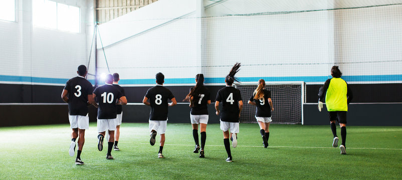 Soccer players training in football field.