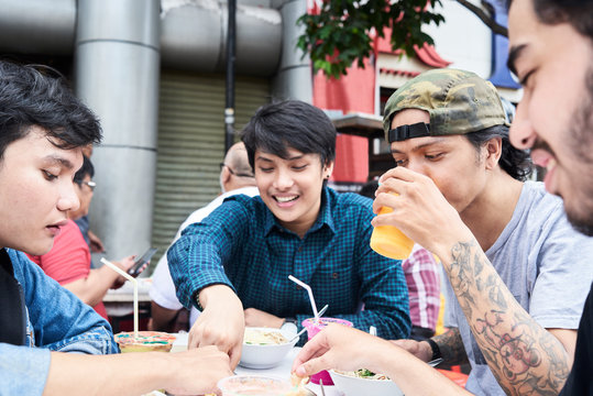 Best friends eating street food and drinking healthy fresh juice.