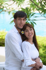 Portraits of couples are happy at the pool area.