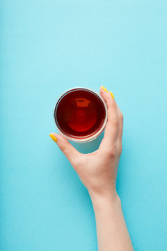 Hand reaches for a glass of tea
