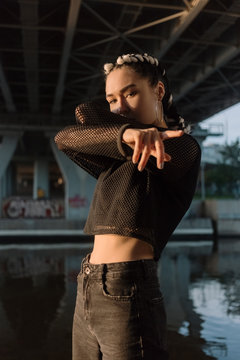 Stylish confident woman under bridge