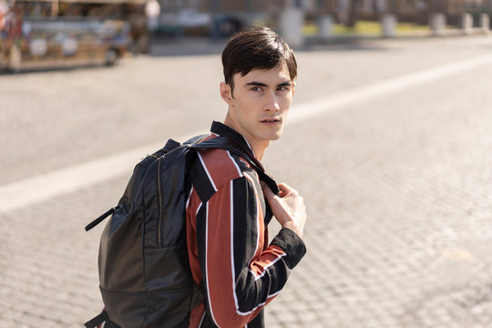 Young Fashionable Student Walking on a Bridge Hading To School