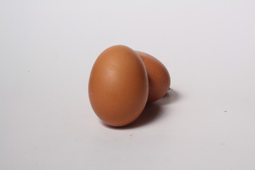 Brown chicken egg on white background