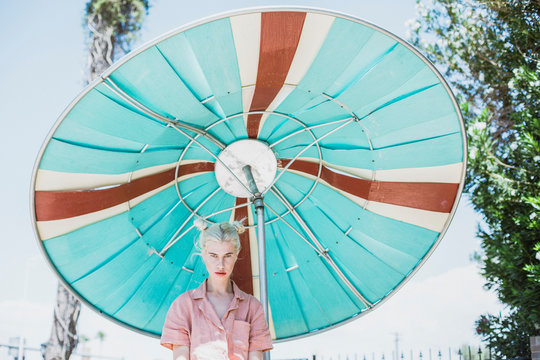 Young woman in front of vintage parasol