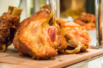 Fried pork leg in a row on a wood.