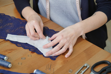 Female tailor working in in the sewing workshop.
