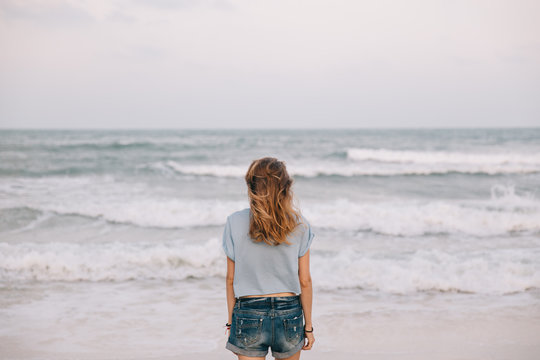 Young woman looking at the sea