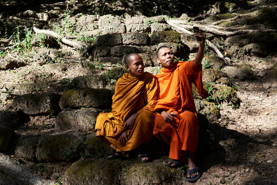 Two monks with cell phone.