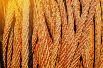 Rusty metal rope wound on a reel. Vintage metal background