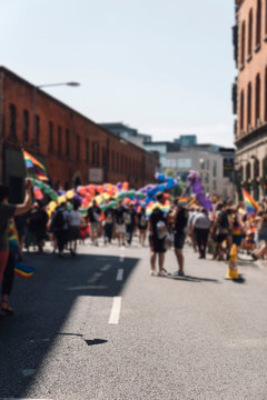 People With Rainbow Flags Attending a Gay pride