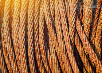 Rusty metal rope wound on a reel. Vintage metal background