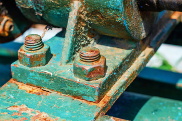 Rusty metal bolts and nuts on metal mounts. Abandoned equipment