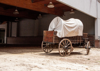 Vintage horse drawn wagon with white canvas top
