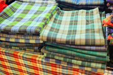 Hand-made fabrics in various colors, stacked together.