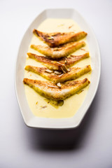 shahi tukra/tukda or Double ka meetha is a bread pudding Indian sweet of fried bread slices soaked in rabid or sweet saffron milk garnished with dry fruits, selective focus