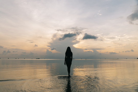 Silhouette of a beautiful woman on the beach