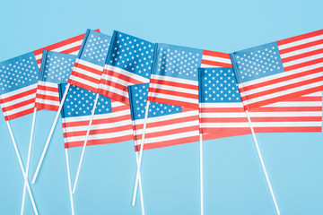 top view of national usa flags on sticks on blue background
