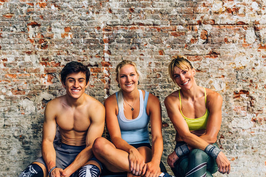 Athletes looking at camera while on bench