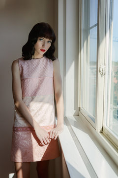 Retro styled portrait of a young woman in a vintage dress