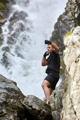 Muay thai fighter training by the waterfall