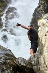 Muay thai fighter training by the waterfall