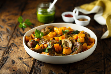 Beef on the bone with pumpkin and pesto