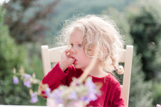 tired little girl sucking her thumb