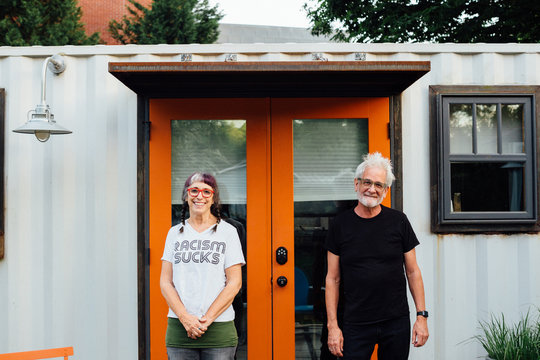Senior couple in front of house