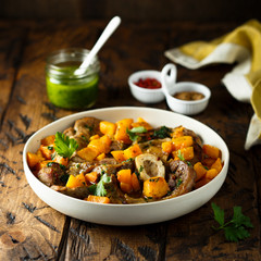 Beef on the bone with pumpkin and pesto
