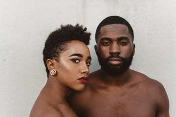 A young black couple facing each other