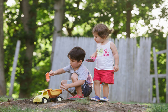 Kids playing with dirt pile