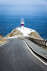 Fototapeta na wymiar lighthouse on road coast of sea