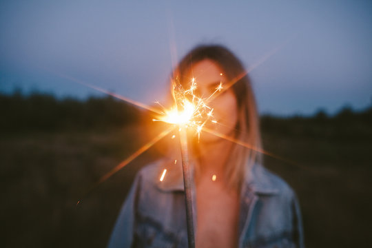 Unrecognizable woman with sparkler