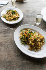 traditional Balinese food called lawar. Lawar is minced meat mixed with vegetables, long beans and spices then stirred evenly. Served on a plate at wooden table